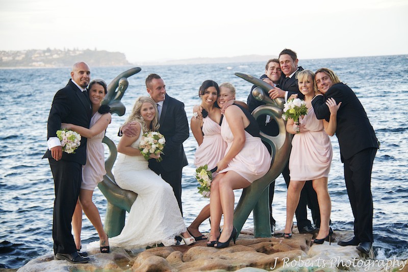 All bridal party hugging along the coast of Manly - wedding photography sydney